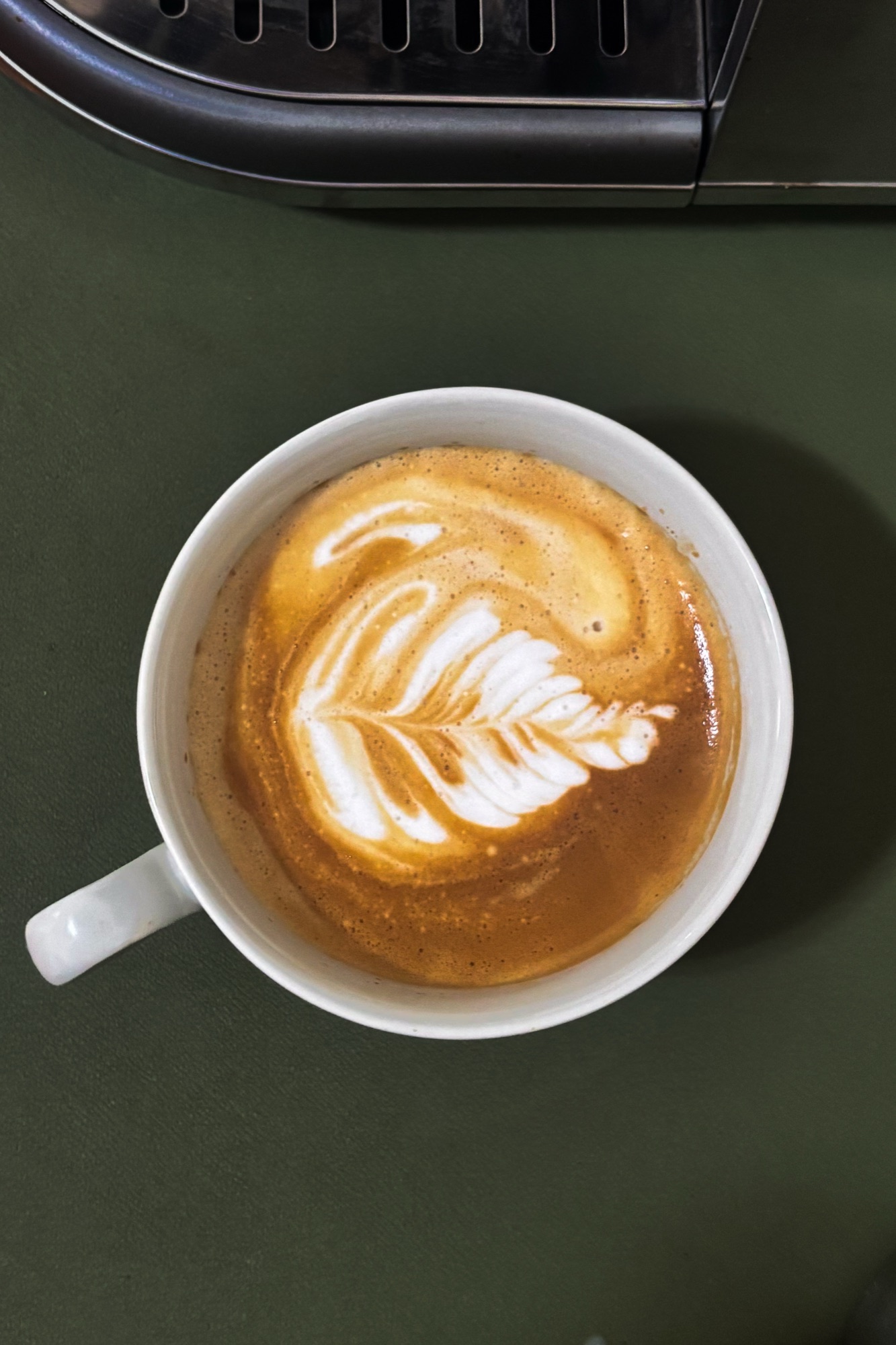 A latte with a rosetta poured into it